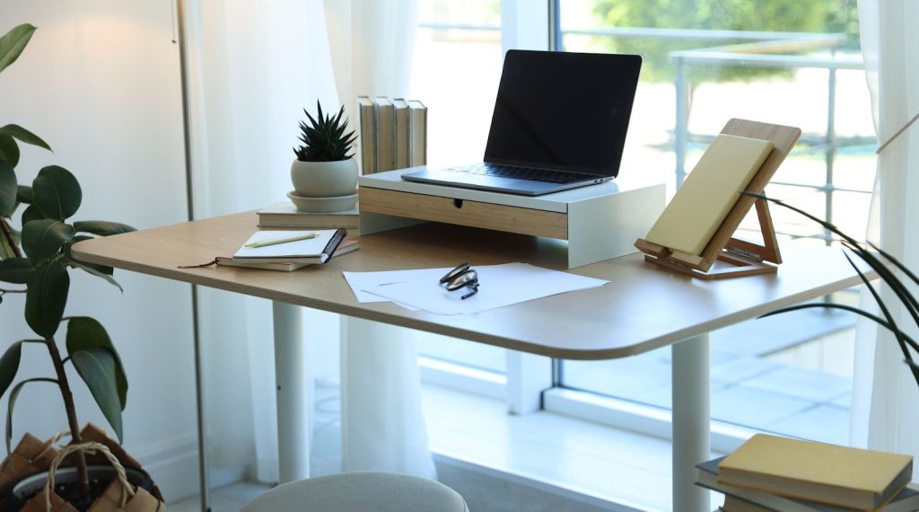 Work desk feng shui setup by a window