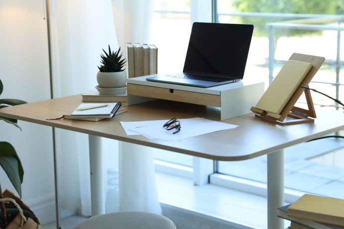 Work desk feng shui setup by a window